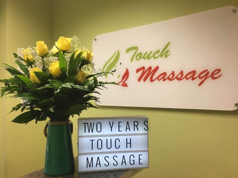 Touch Massage sign with flowers, celebrating two years