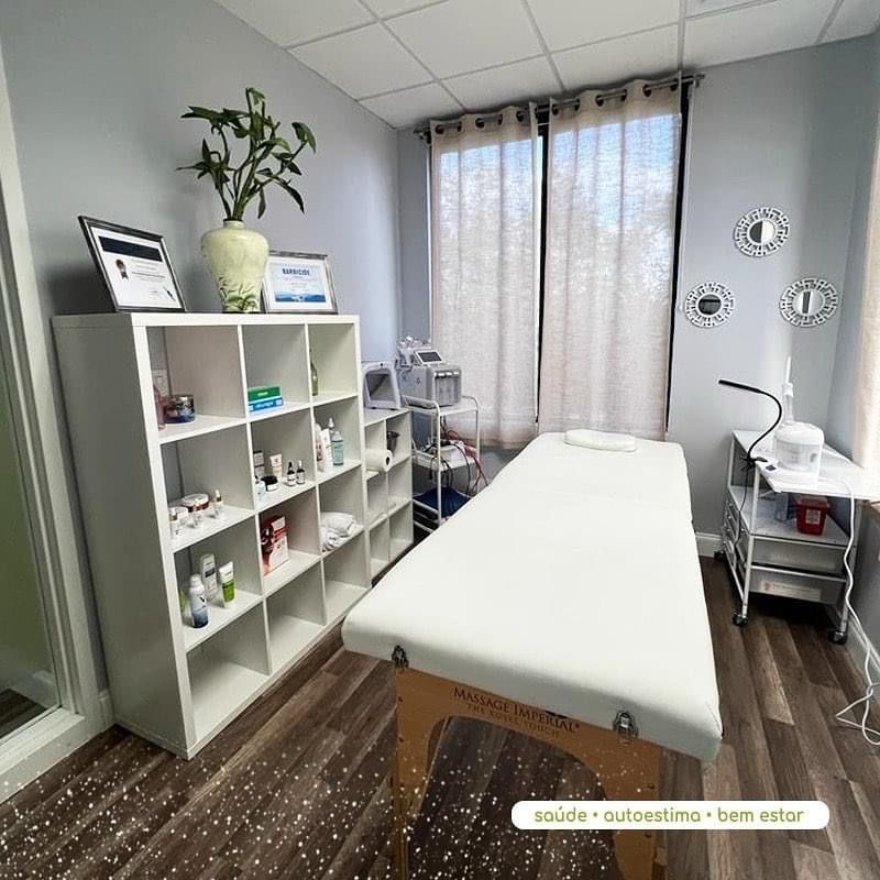 Clean, calming treatment room with massage table and product shelf